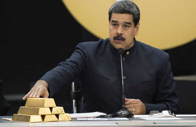 
Tổng thống Venezuela Nicolas Maduro cầm trên tay những thỏi vàng. (Ảnh: Reuters)

