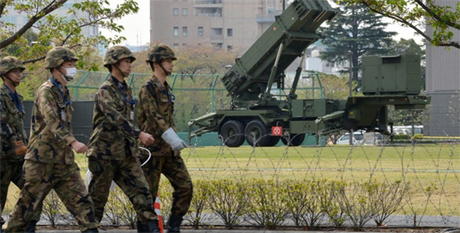 Các binh sĩ Nhật đang đi gần hệ thống đánh chặn tên lửa PAC-3 tại Bộ quốc phòng ở Tokyo.