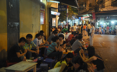 Khách nước ngoài thích thú khi được ngồi uống bia vỉa hè ở phố đi bộ Tạ Hiện