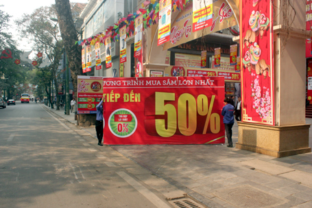 Một cửa hàng điện máy trên phố Tràng Thi đang chuẩn bị những tấm biển giảm giá dịp cuối năm